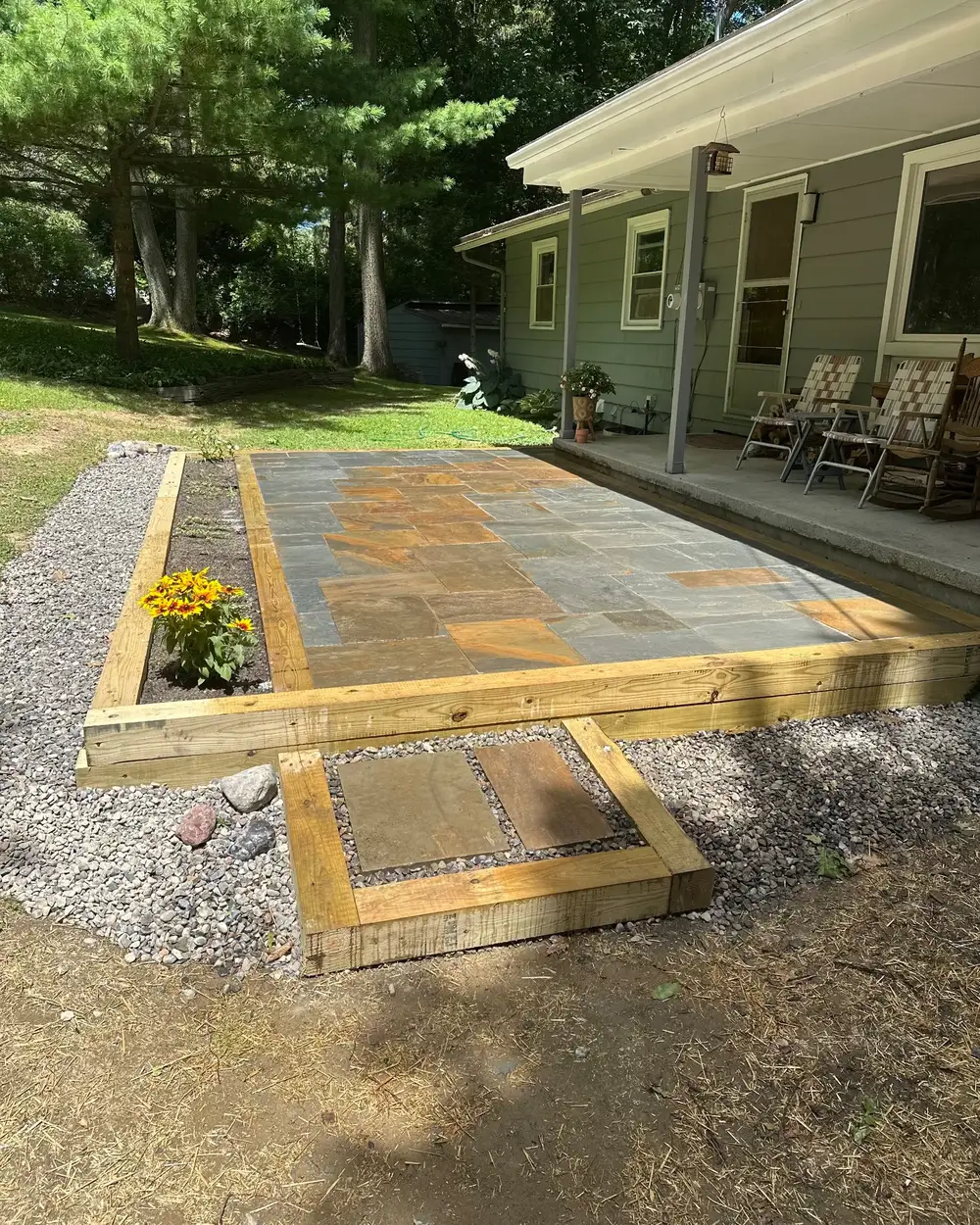 A bluestone patio with a timber border and a stepping-stone landing