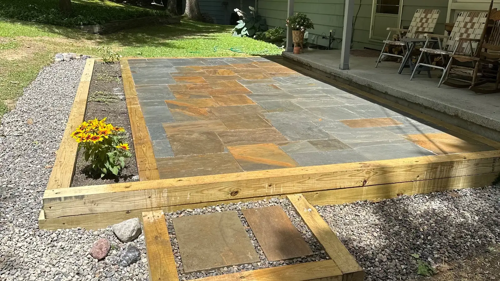 A bluestone patio with a timber border and a stepping-stone landing