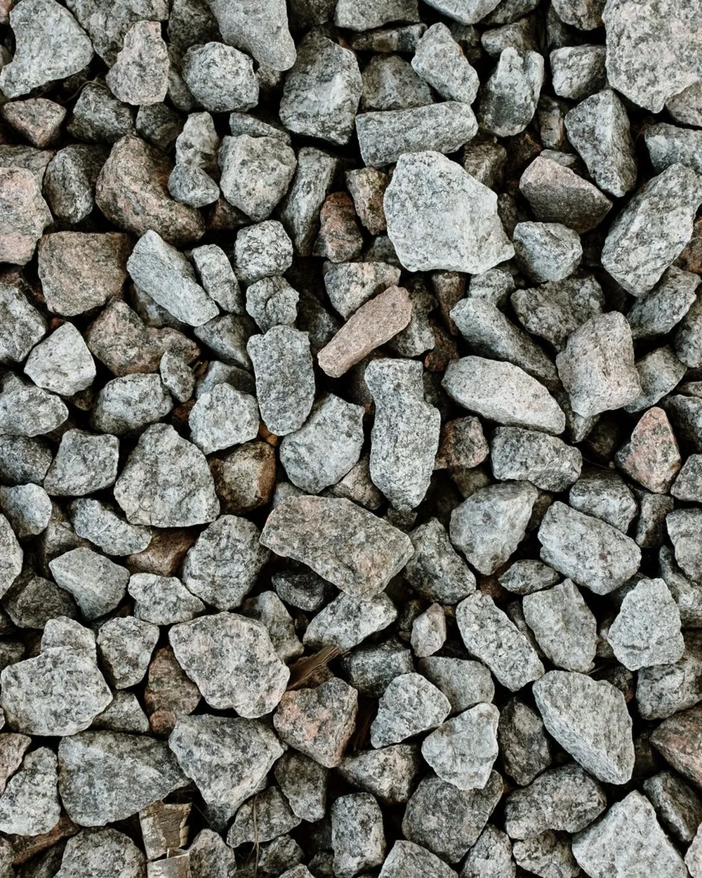 Crushed grey granite stone, the size used for driveways and drainage